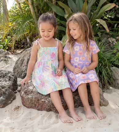 Generated with Kive.ai - 2 girls wearing and wearing sitting the same as the reference photo. she looks down with a soft_ peaceful smile as if carefully watching where she steps. Mood is light_ whol